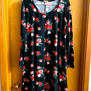 This is an adorable black dress with rose clusters.